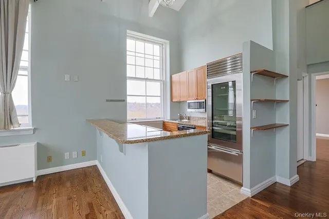 a kitchen with stainless steel appliances granite countertop a refrigerator and a sink