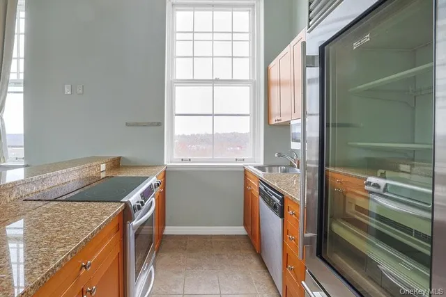 a kitchen with granite countertop a sink and a stove