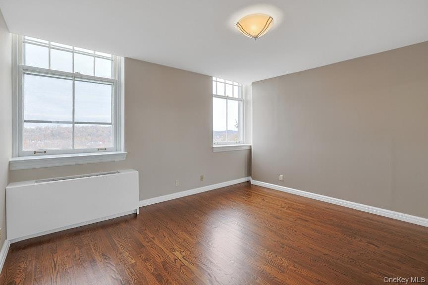 1701 Crompond Road, Unit 6304 Peekskill, NY 10566 - Photo 3 of 23 an empty room with wooden floor and windows