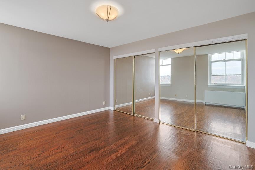 1701 Crompond Road, Unit 6304 Peekskill, NY 10566 - Photo 4 of 23 an empty room with wooden floor and windows