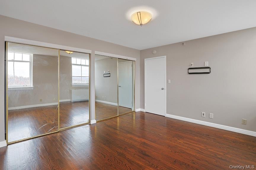1701 Crompond Road, Unit 6304 Peekskill, NY 10566 - Photo 5 of 23 an empty room with wooden floor and windows