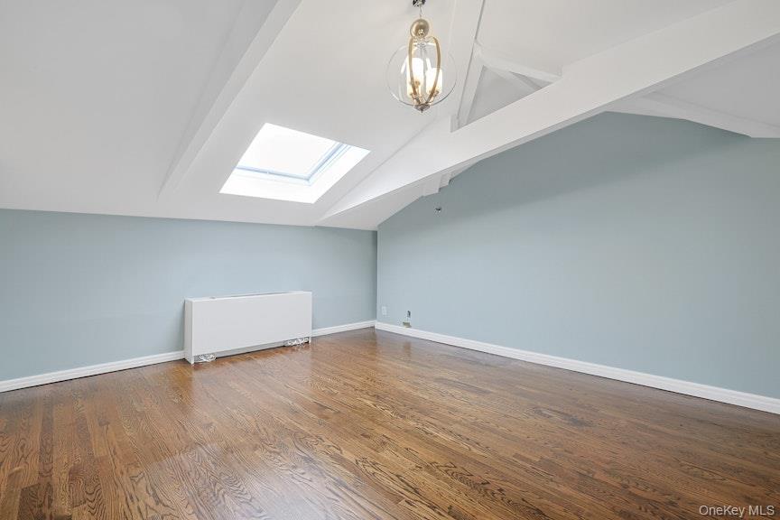 1701 Crompond Road, Unit 6304 Peekskill, NY 10566 - Photo 8 of 23 an empty room with wooden floor and chandelier