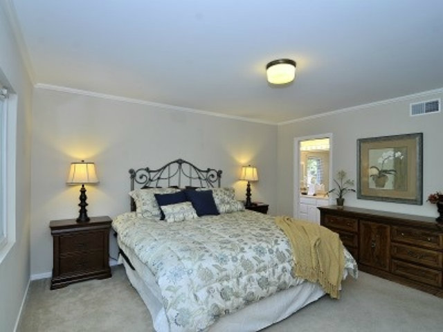 651 Covington Road Los Altos, CA 94024 - Photo 11 of 21 a bedroom with a bed and a lamp on dresser