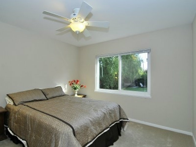 651 Covington Road Los Altos, CA 94024 - Photo 14 of 21 a bedroom with a bed and a chandelier