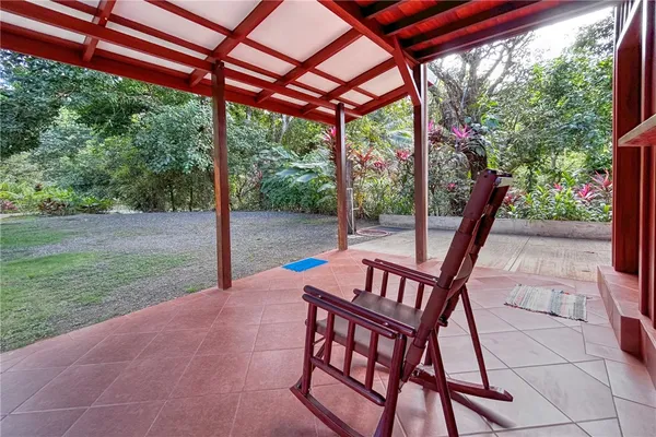 a view of a patio with table and chairs under an umbrella