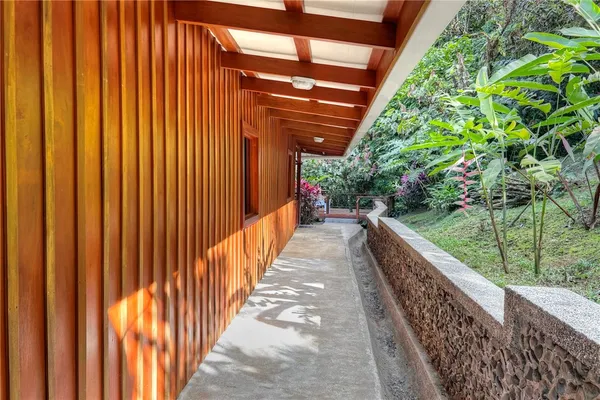 a front view of a house with a tree