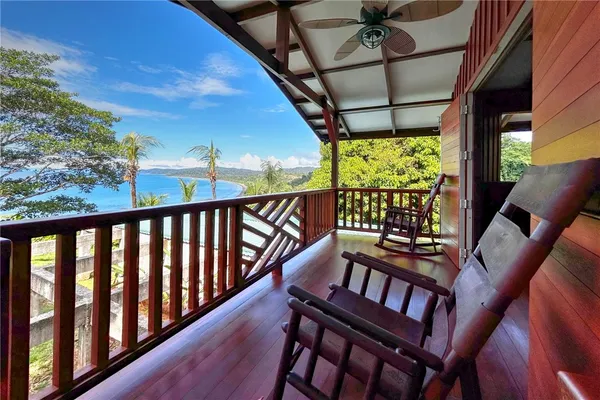 a view of house with outdoor space and tub