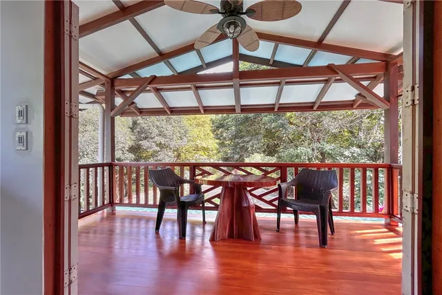 a view of a porch with furniture and a tub