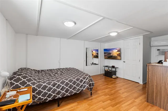 a bedroom with furniture and a wooden floor