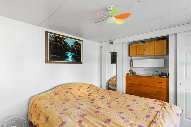 a bedroom with a bed and a painting on the wall