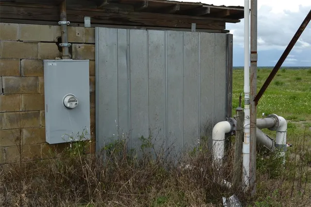 a view of a big yard and an ocean view