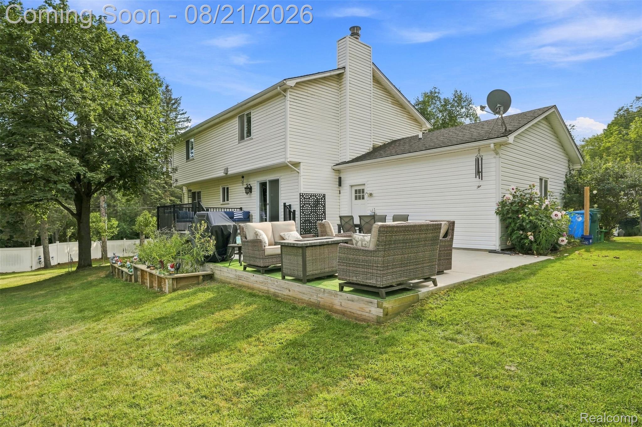 6060 Ford Road Commerce Township, MI 48382 - Photo 38 of 58 Expansive backyard featuring a manicured lawn, a large patio, and established trees