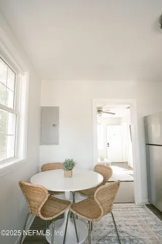 a view of a dining room with furniture and a window