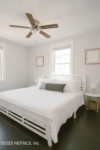 a bedroom with a bed and window