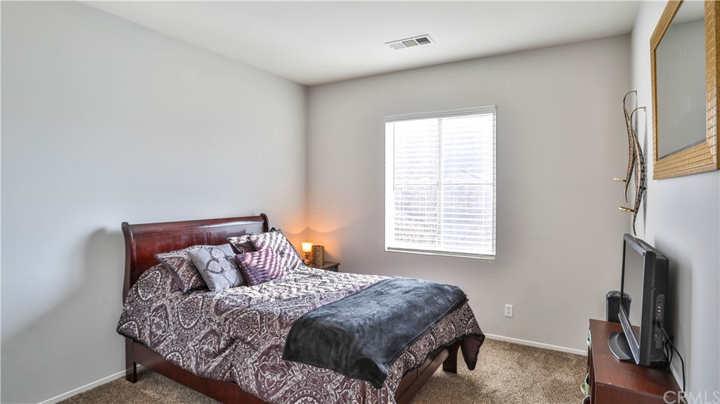 12179 Dewar Drive Riverside, CA 92505 - Photo 21 of 28 a bed sitting in a bedroom next to a window