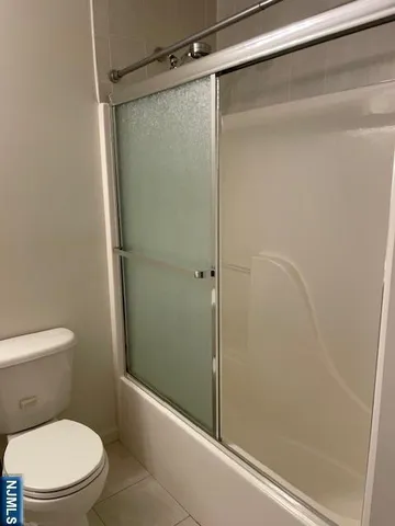 a bathroom with a shower and a toilet