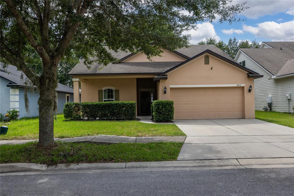 8216 Northwest 54th Street Gainesville, FL 32653 - Photo 2 of 58 a front view of a house with a yard and garage