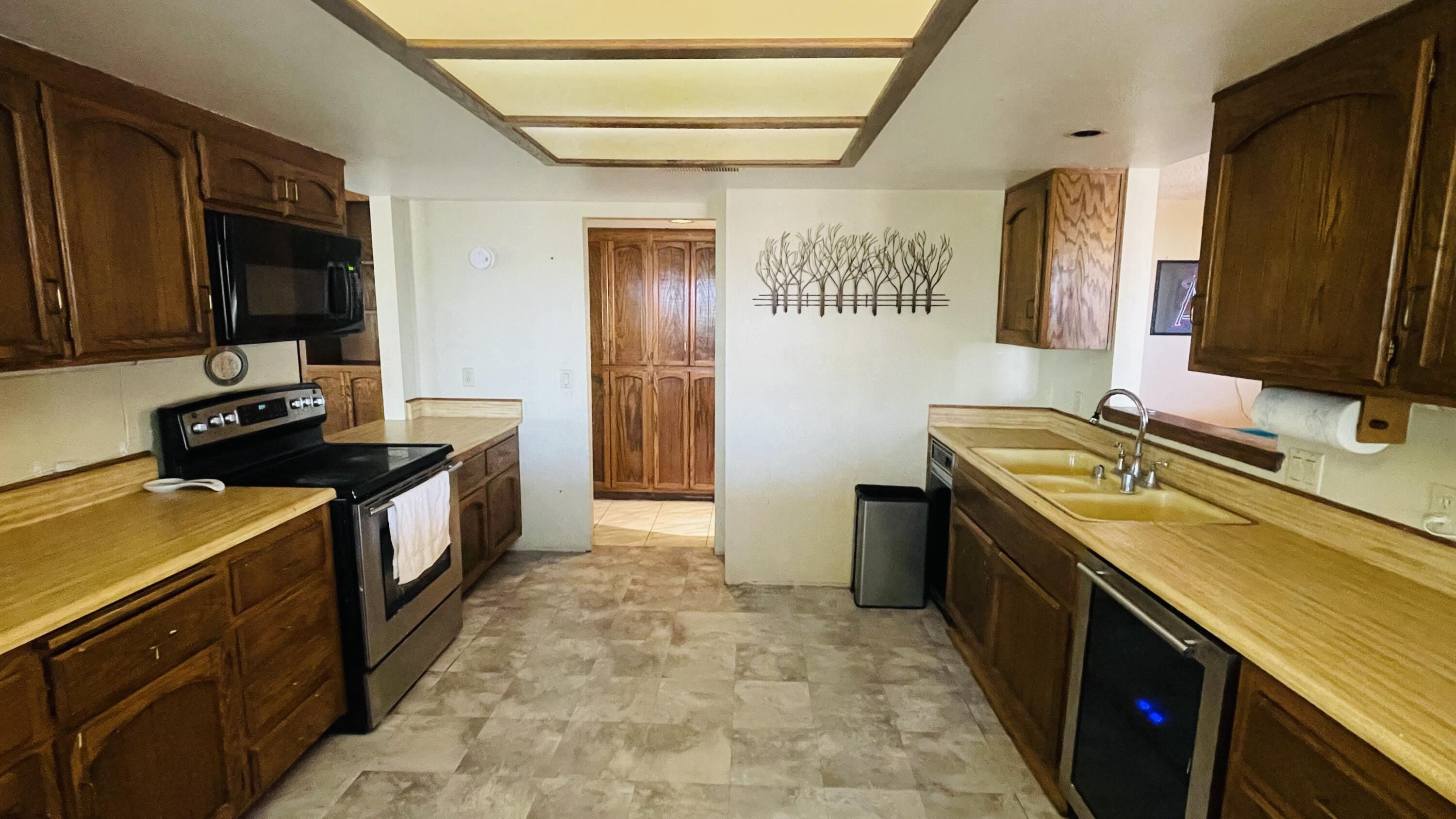 1498 Nile Drive Thermal, CA 92274 - Photo 35 of 108 a kitchen with a sink stove and refrigerator