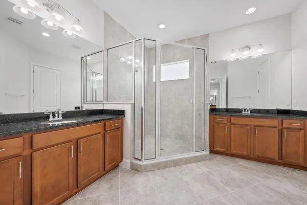 a bathroom with a granite countertop sink mirror and double