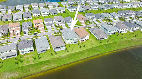 an aerial view of residential houses with outdoor space and street view