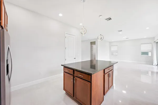 a kitchen with stainless steel appliances granite countertop a sink a stove and a refrigerator