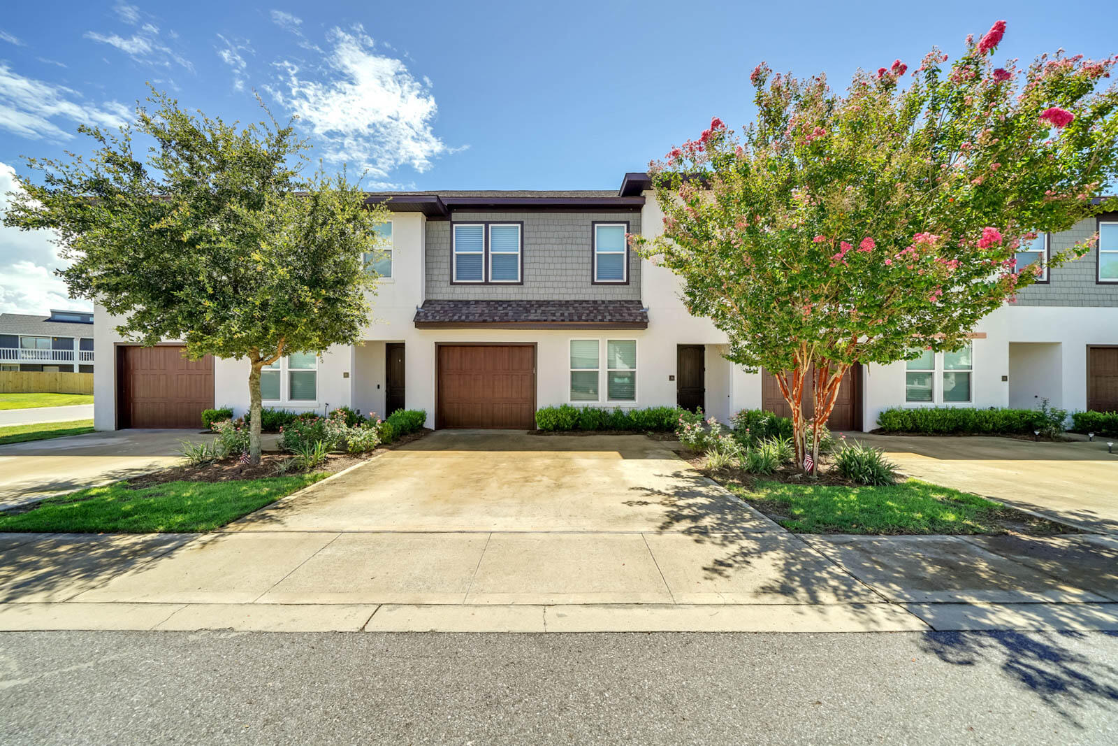 995 Airport Road, Unit 39 Destin, FL 32541 - Photo 1 of 37 a front view of a house with a yard and a garage