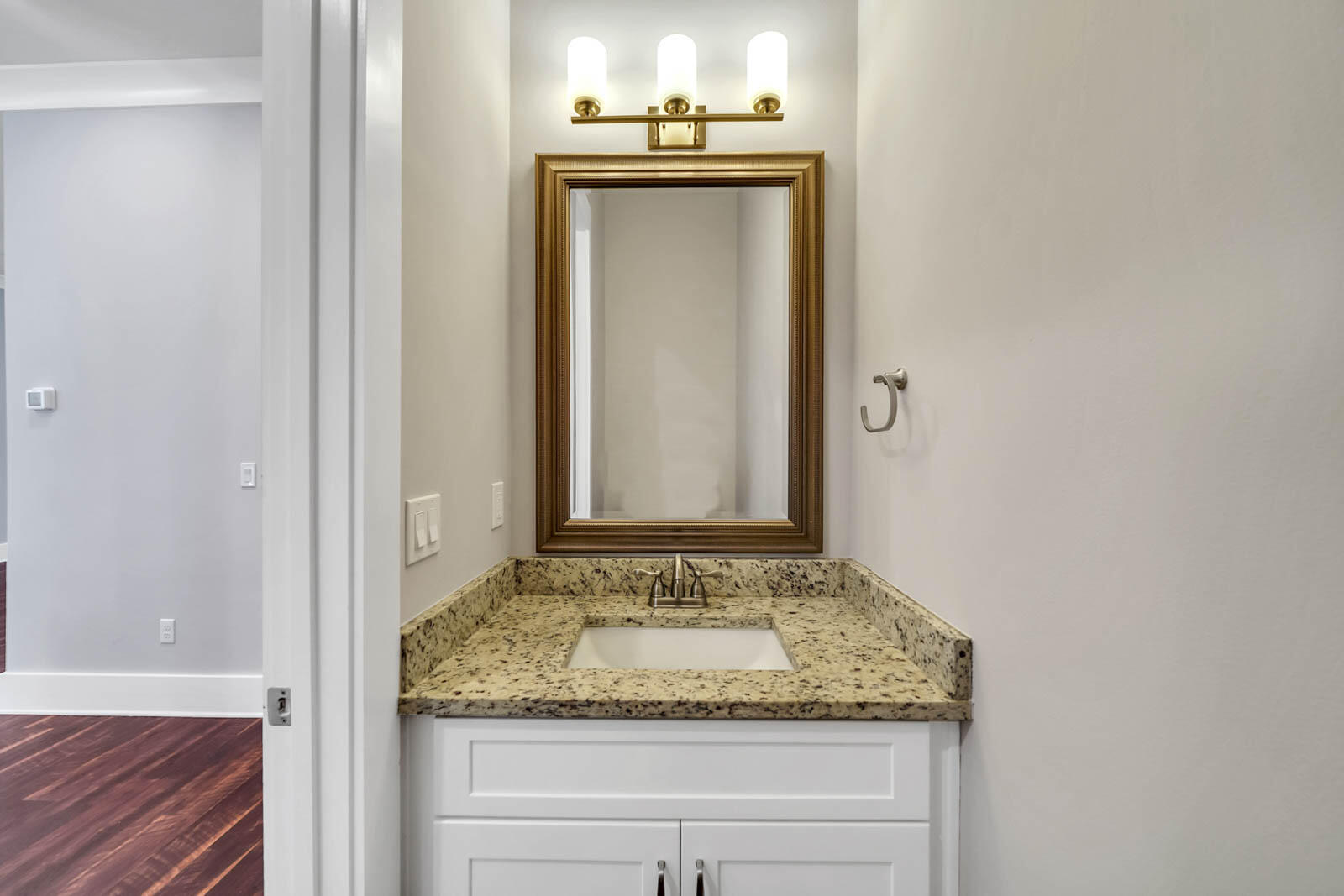995 Airport Road, Unit 39 Destin, FL 32541 - Photo 12 of 37 a bathroom with a granite countertop sink and a mirror