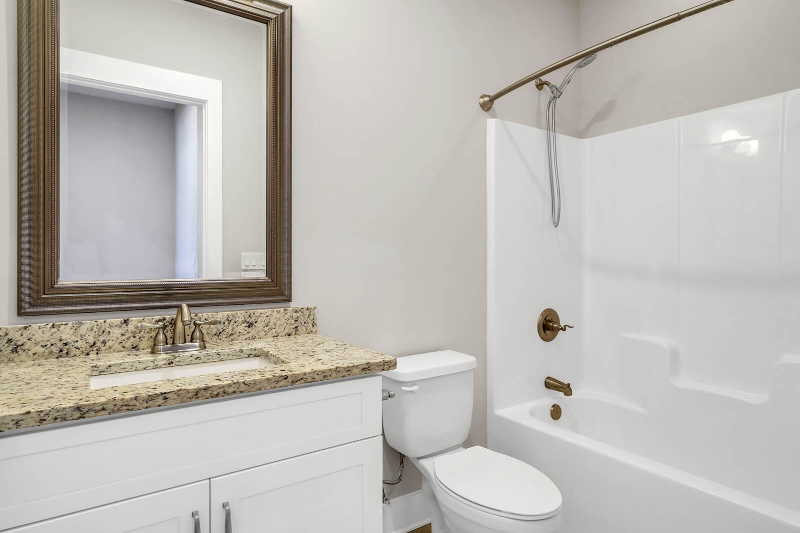 995 Airport Road, Unit 39 Destin, FL 32541 - Photo 26 of 37 a bathroom with a granite countertop sink toilet mirror and shower