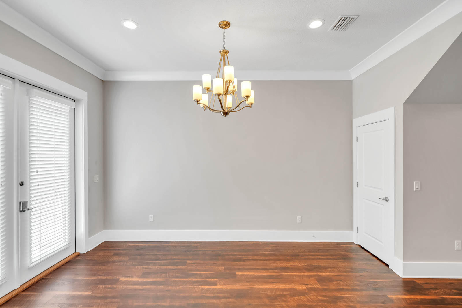 995 Airport Road, Unit 39 Destin, FL 32541 - Photo 8 of 37 an empty room with wooden floor and windows
