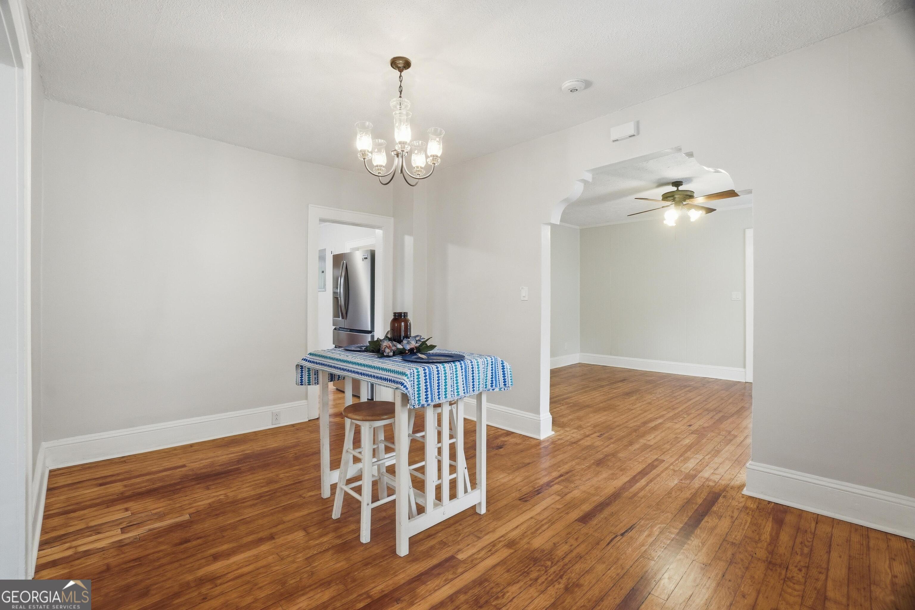 3022 Maple Road Southeast Lindale, GA 30147 - Photo 7 of 29 a view of a room with wooden floor and chandelier