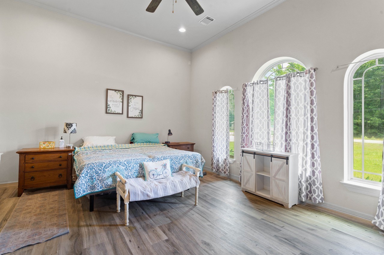 27585 Rio Blanco Drive Splendora, TX 77372 - Photo 20 of 39 Welcome to the huge primary bedroom overlooking the front yard. Beautiful and big windows allow the natural light to shine in and make this room bright!