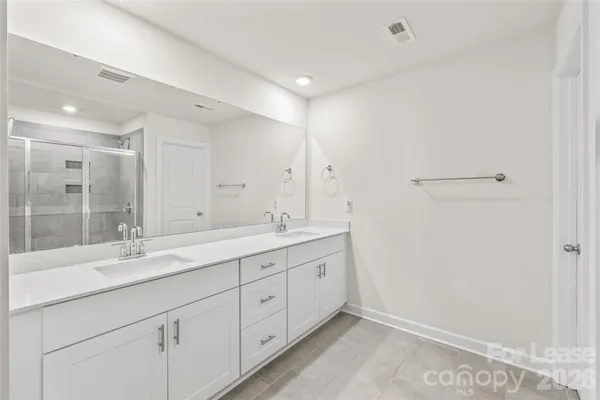 a bathroom with a glass shower door