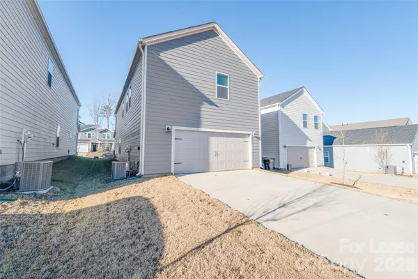 an aerial view of residential houses and snow on the road