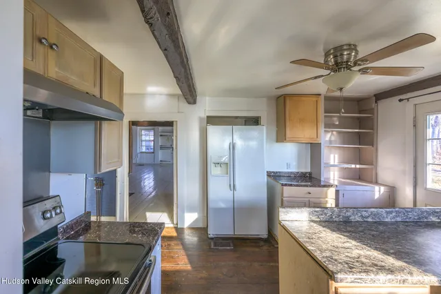 a kitchen with stainless steel appliances granite countertop a refrigerator a sink and a stove