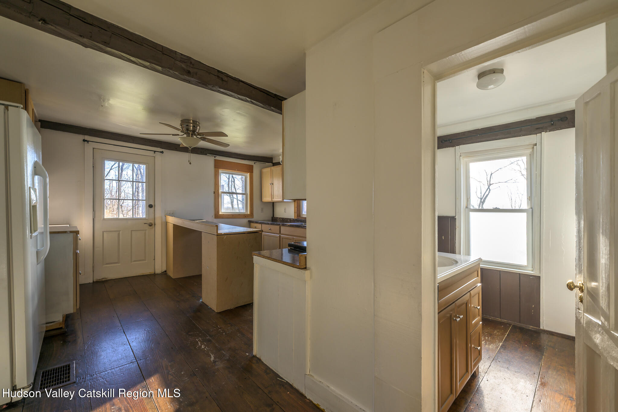 91 Scheller Park Road New Baltimore, NY 12192 - Photo 17 of 26 a view of a hallway with wooden floor and a living room