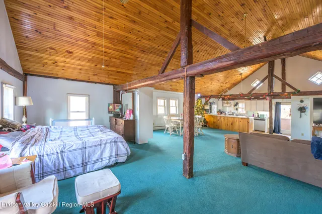 a bedroom with furniture and a large window