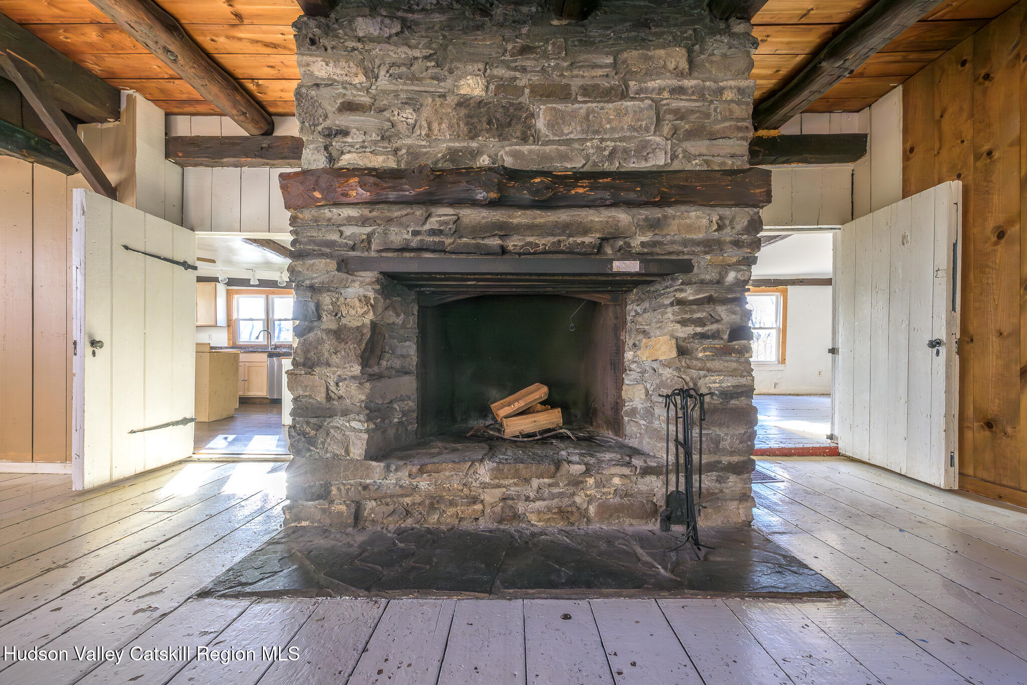 91 Scheller Park Road New Baltimore, NY 12192 - Photo 8 of 26 a view of a livingroom with wooden floor and a fireplace
