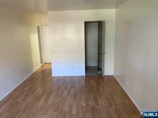 1111 River Road, Unit F2 Edgewater, NJ 07020 - Photo 12 of 21 an empty room with wooden floor and closet