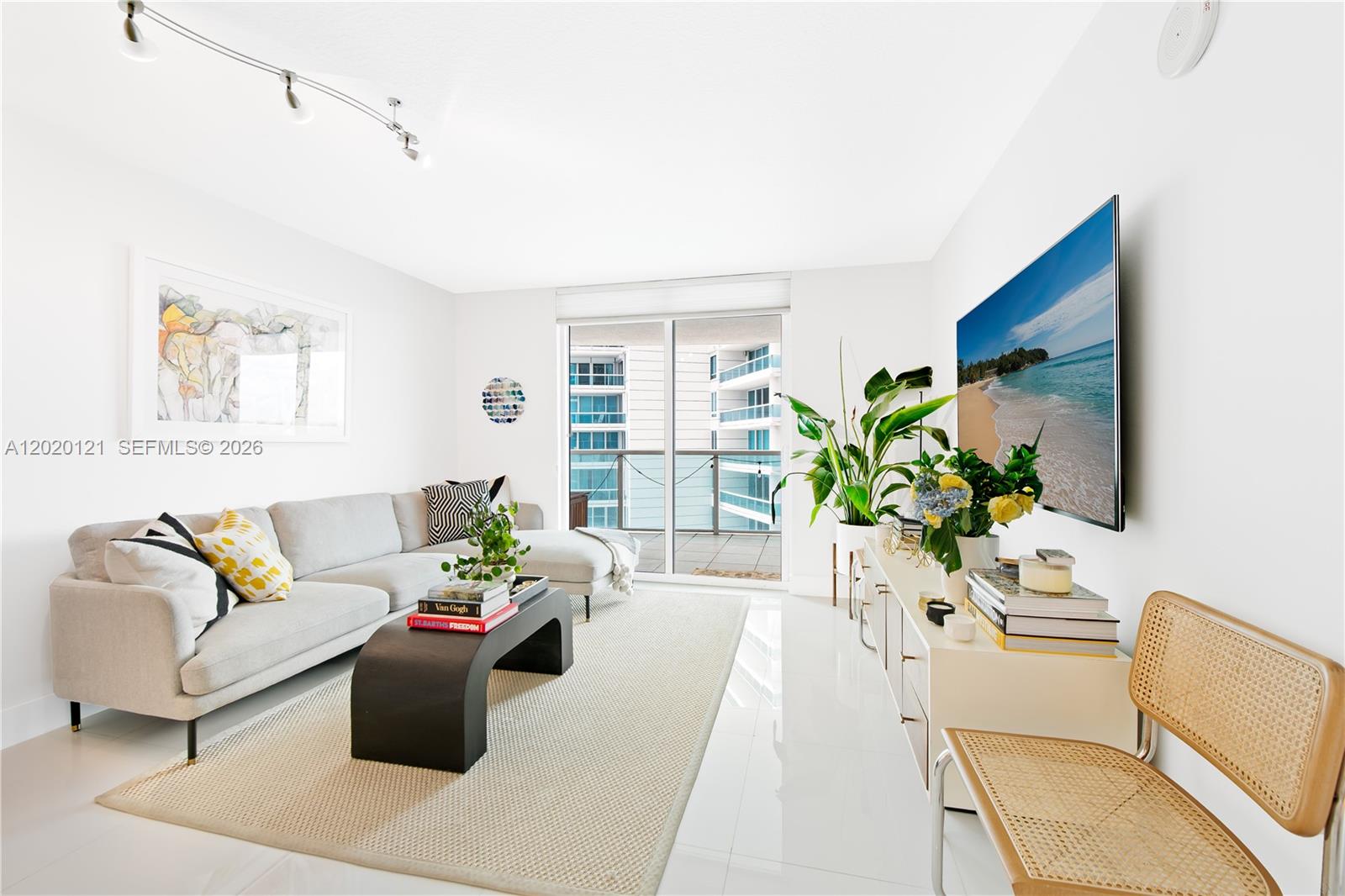 2101 Brickell Avenue, Unit 1909 Miami, FL 33129 - Photo 5 of 25 a living room with furniture potted plant and a window