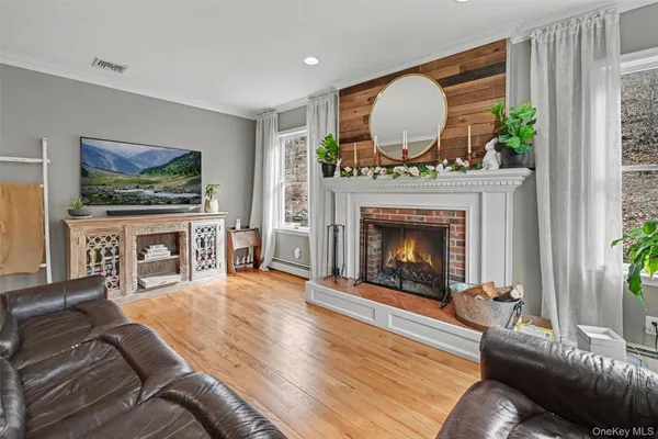 a living room with furniture a fireplace and a flat screen tv