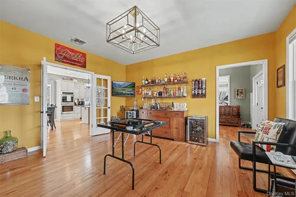 a view of a room with furniture and wooden floor