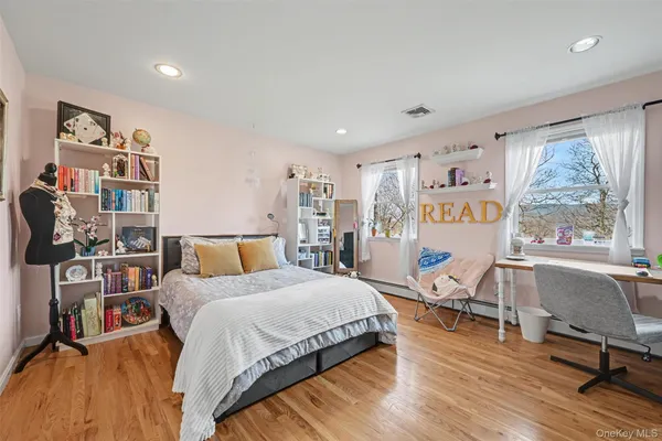 a spacious bedroom with a bed a table and a large window