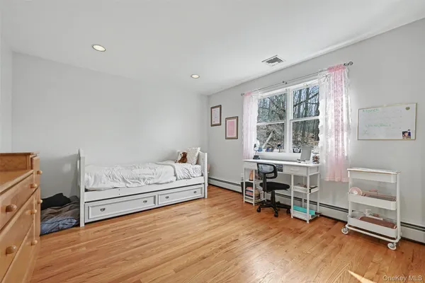 a bedroom with furniture and a wooden floor