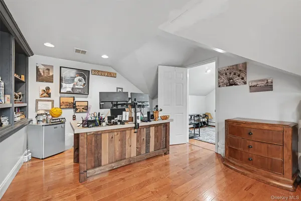 a kitchen with stainless steel appliances kitchen island granite countertop a stove top oven a sink a dining table and chairs with wooden floor
