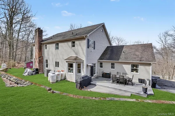 a front view of house with yard and green space