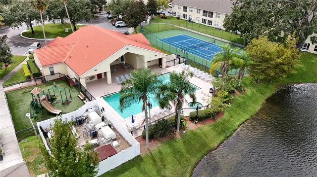 an aerial view of a house with garden space and lake view