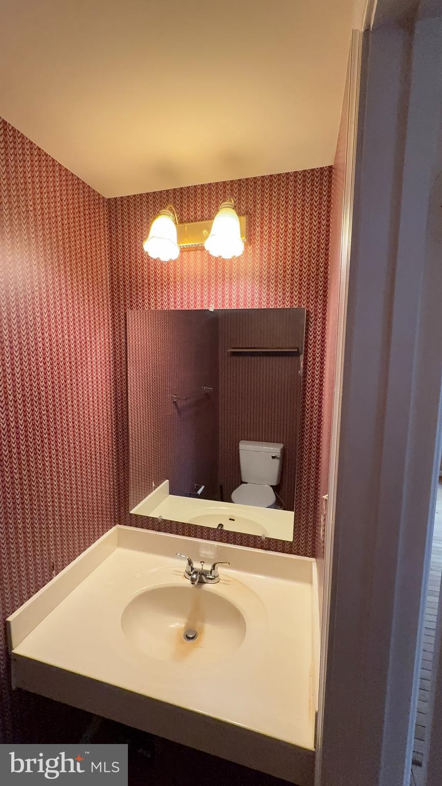 7907 Gambrill Court Springfield, VA 22153 - Photo 12 of 35 a bathroom with a sink and a mirror