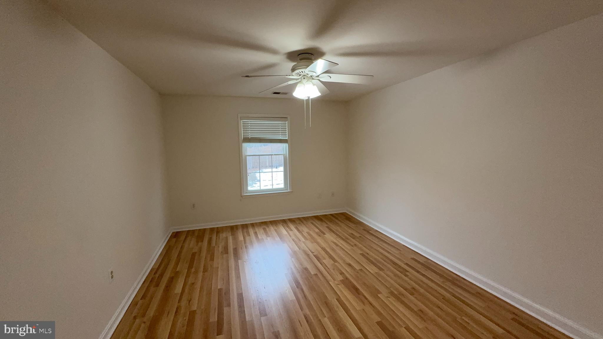 7907 Gambrill Court Springfield, VA 22153 - Photo 18 of 35 wooden floor in an empty room with a window