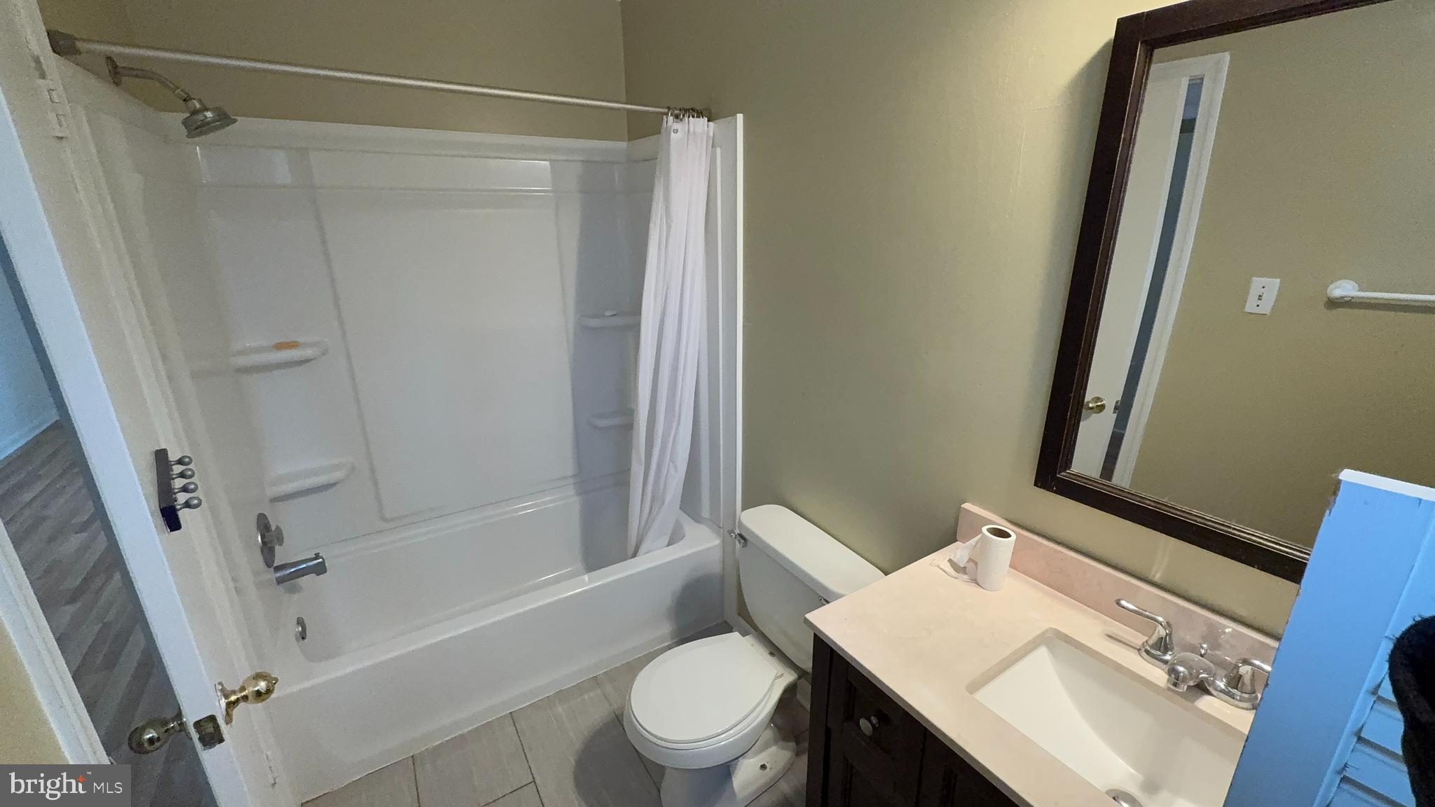 7907 Gambrill Court Springfield, VA 22153 - Photo 21 of 35 a bathroom with a sink a toilet a mirror and shower