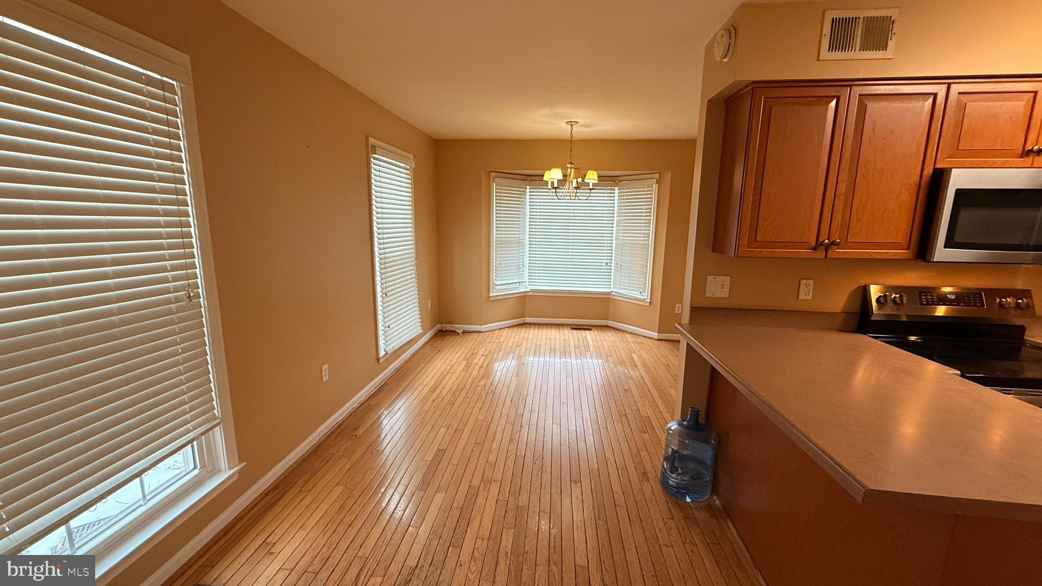 7907 Gambrill Court Springfield, VA 22153 - Photo 26 of 35 a kitchen with wooden floors and a sink